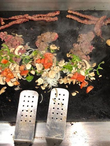 grilling meat and vegetables for a sub